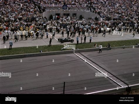 Race Cars And Spectators Are Visible At The Indianapolis 500 Automobile