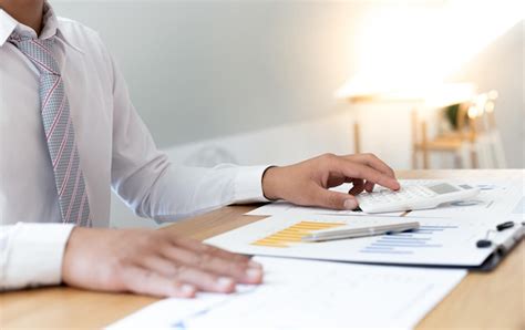 Premium Photo Midsection Businessman Using Calculator While Working