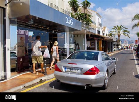 Luxury Car And Shops At The Exclusive Yacht Harbour Of Puerto Ban S