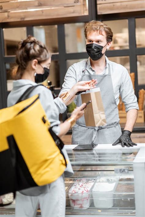 Courier Taking Online Order For Delivery In The Shop Stock Image