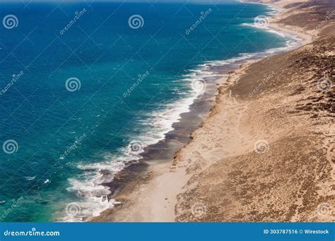 Beautiful Beach With Crystal Clear Blue Waves Gently Crashing Onto The