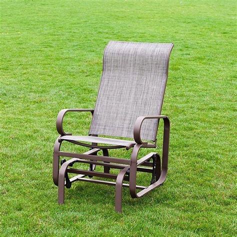 A Rocking Chair Sitting In The Middle Of A Grassy Field On Top Of Green Grass