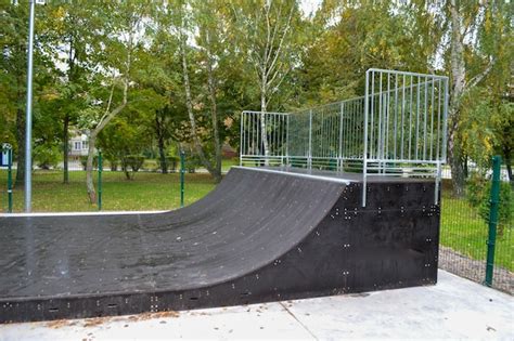 Premium Photo | Skatepark ramps in the park on autumn