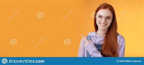 Friendly Good Looking Modern Redhead Young Girl Pointing Left Index