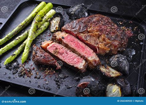 Barbecue Dry Aged Wagyu Rib Eye Beef Steaks With Green Asparagus And