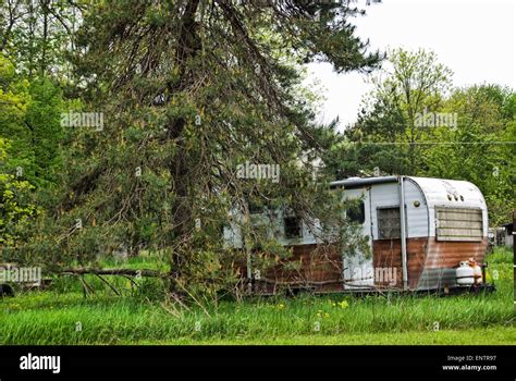 Rundown Camper Trailer In The Woods Stock Photo Alamy