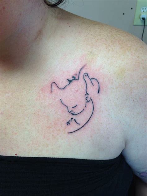 Very Simplistic Tattoo Of A Mother Holding Her Baby Simplistic