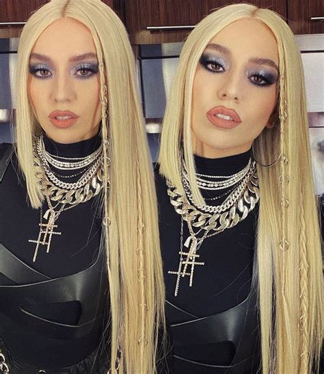 two women with blonde hair wearing chokers and necklaces, posing for ...