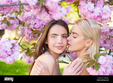 Portrait Of A Two Beautiful Spring Girls Two Young Women Relaxing In Sakura Flowers Lesbian