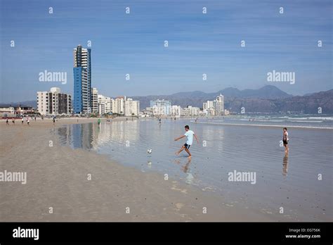 Two young boys playing soccer on a beach Stock Photo - Alamy