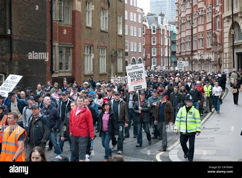 UK police officers and supporters march through central London to protest at the 20% government ...