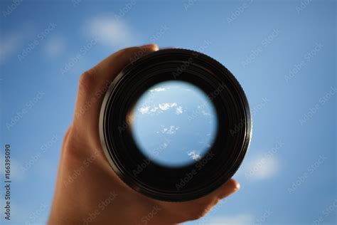 View Through Spyglass Lens To The White Clouds In The Sky Stock Photo