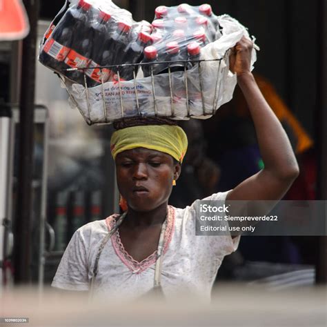 Unidentified Ghanaian Woman Carries A Basket With Bottles Of Water On