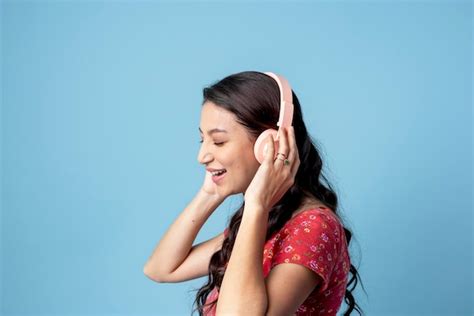 Premium Photo Cheerful Woman Listening To Music With A Headset On