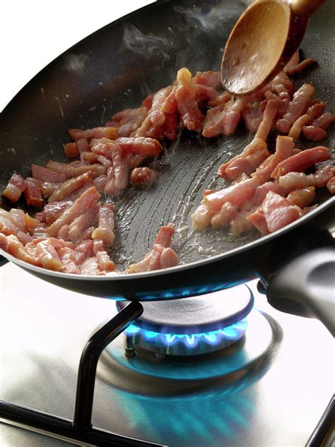 Cuisson De Lardons A La Poele Cooking Diced Bacon In A Frying Pan