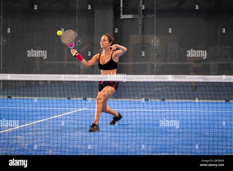 Woman Playing Padel In A Blue Grass Padel Court Indoor Young Sporty