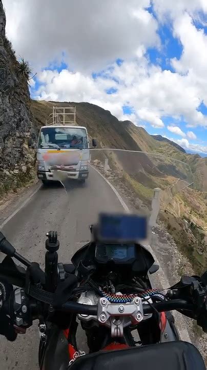 Biker Has Close Call With Oncoming Truck On Narrow Mountain Road