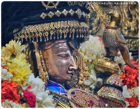 An Elaborately Decorated Statue With Flowers In The Foreground And A