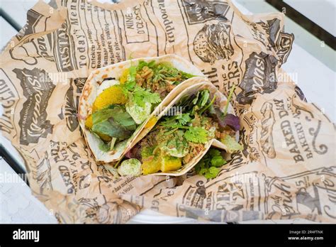 Two Healthy Beautiful Looking Tacos In Served In Wrinkled Greaseproof