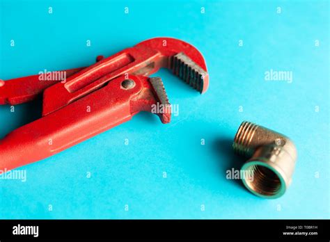 A Monkey Wrench On The Blue Background With Some Fitting Connectors