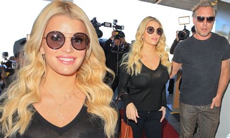 Jessica Simpson Flashes Bra At Lax With Husband Eric Johnson Daily Mail Online