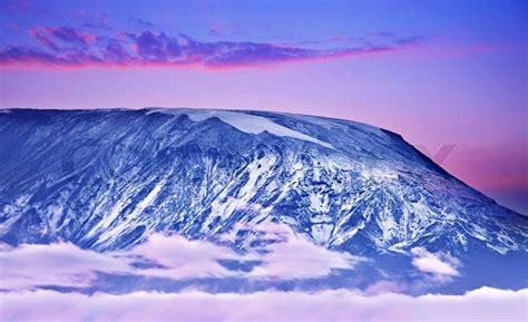 Kilimanjaro at sunset, giant volcano mount, mountain covered with snow, beautiful landscape ...