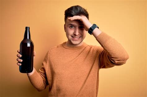 Premium Photo Young Handsome Caucasian Man Drinking A Bottle Of Beer