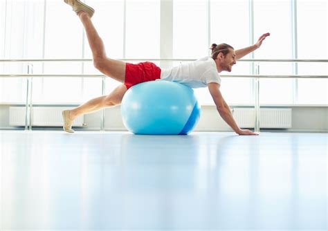 Free Photo Man Stretching With Yoga Ball