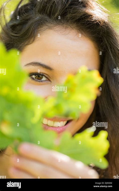 Gorgeous Content Brunette Holding A Leaf Stock Photo Alamy
