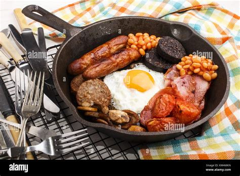 full irish breakfast with fried egg, sausages, black pudding, white ...