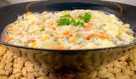 A Bowl Filled With Food Sitting On Top Of A Woven Place Mat Next To A