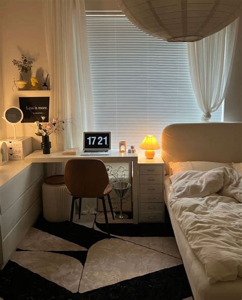 A Bed Room With A Neatly Made Bed And A Desk