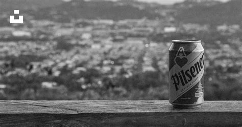 A Can Of Beer Sitting On Top Of A Wooden Table Photo Free Alcohol Image On Unsplash