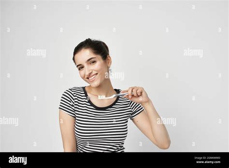 Brunette Brush Your Teeth With A Toothbrush Light Background Stock