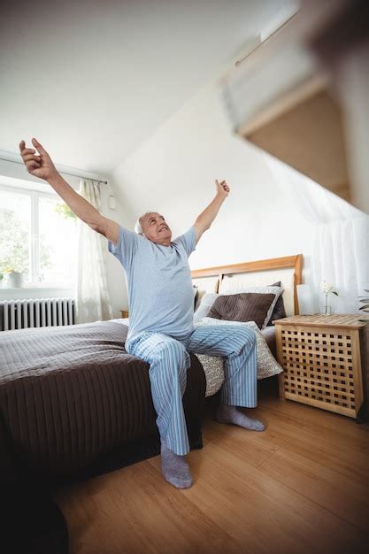 Premium Photo Senior Man Yawning On Bed