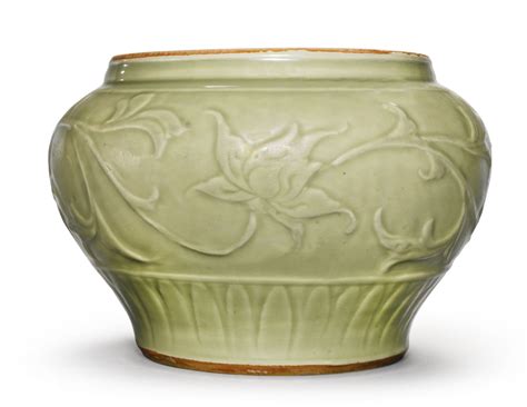 A Carved Longquan Celadon Jar Guan Yuan Dynasty Heavily Potted And