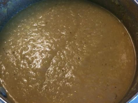 A Pot Filled With Soup Sitting On Top Of A Stove