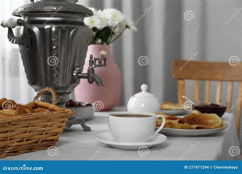 Vintage Samovar Cup Of Hot Drink And Snacks Served On Table Indoors