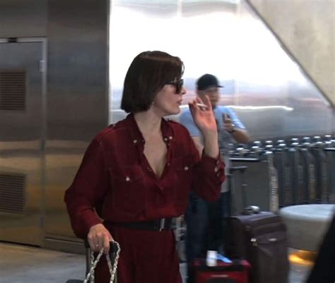 Milla Jovovich Smoking A Cigarette At Lax Airport In Los Angeles 0204