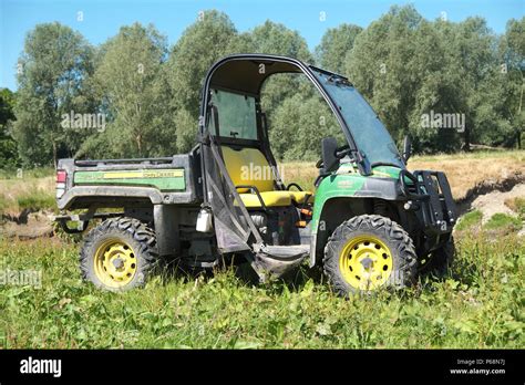 John Deere 855 Gator 4WD utility vehicle in a rural field in England UK ...