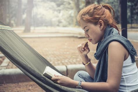 Premium Photo Young Woman Reading Book While Sitting On Hammock