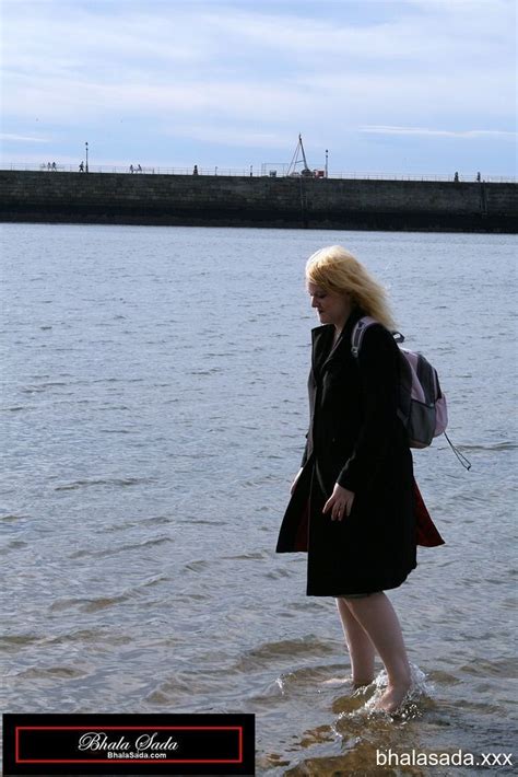 Solo Blonde Hottie Washing Her Feet In A River Photos