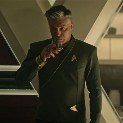 a man in a star trek uniform holding a cell phone