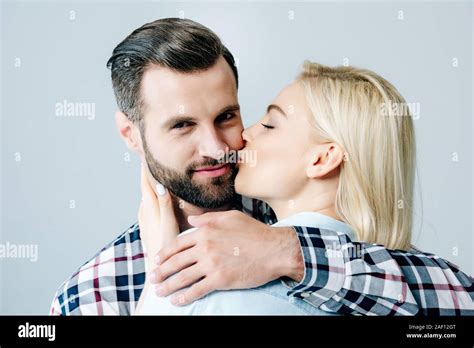 Beautiful Blonde Girl Kissing Handsome Man Isolated On Grey Stock Photo Alamy