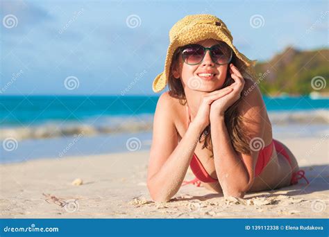 Long Haired Woman In Bikini And Straw Hat Lying On Tropical Beach Stock