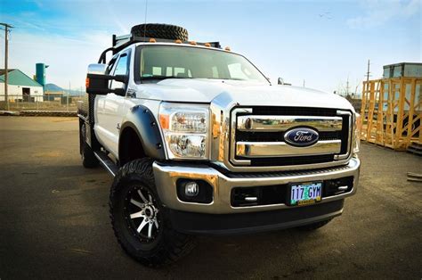 A Silver Truck Parked In A Parking Lot