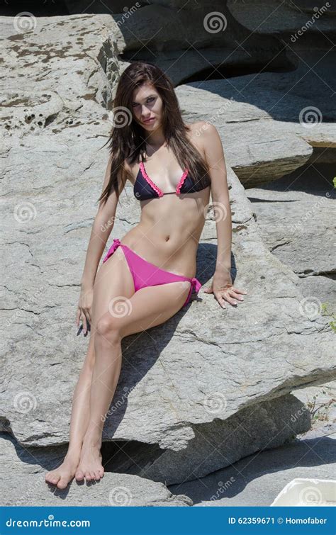 Slim Female In Bikini Leaning On Sea Rocks Stock Image Image Of Length Rocky 62359671