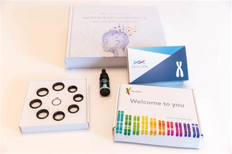 Hand Holds Saliva Collection Kit Tube From 23andme With Open Funnel Lid