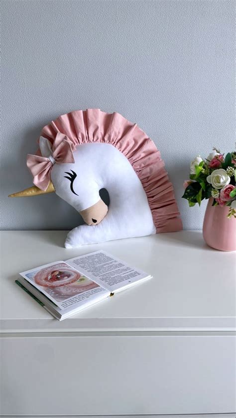 a stuffed unicorn head sitting on top of a white dresser