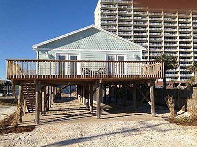 the beach house is next to an oceanfront hotel and has two decks on it